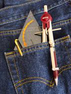 Close-up of the colorful school supplies in the pocket, of the jeands