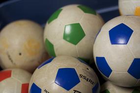 Colorful, shiny soccer balls, with the reflctions