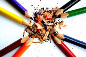 sharpener of colorful pencils on paper