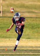 American football player gives the ball