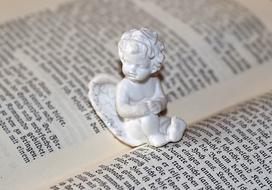 porcelain angel on an open book