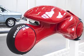 Red and black design of the glossy motorcycle with a person of "Good Year"