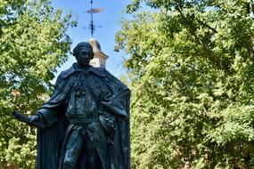 Statue of William Mary, among the green trees and near the university in Williamsburg Virginia, USA