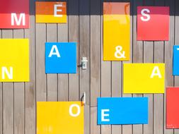 letters on colorful cards on wooden wall