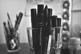 Pens and markers in Glasses on desk, Black And White
