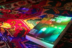 book in chinese on a colorful carpet