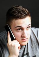 photo portrait of a young man with a phone