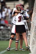 Lacrosse, two uniformed Girls hugging