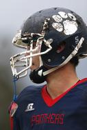 American Football Player in weathered helmet