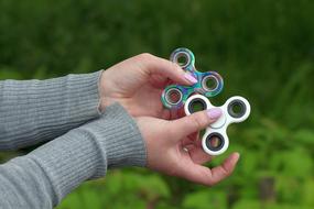 two spinners in hand