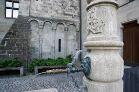 Beautiful, patterned fountain in Zurich, Switzerland, among the buildings