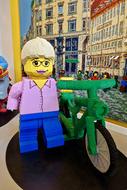 lego figurine with green bike