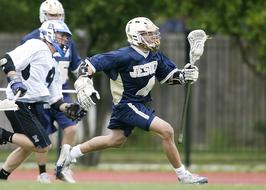 Players, playing Lacrosse, on the court, among the trees