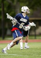 Lacrosse players, on the green grass field
