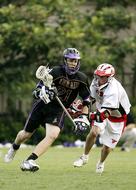 players with sticks on the field in lacrosse