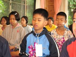 Children meditating in Buddhists School