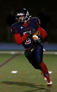 Football American Runner on the field at night