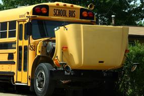 yellow school bus with open hood