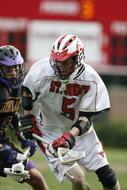 lacrosse players action in blurred background