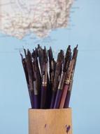 ink pens in a wooden glass for school