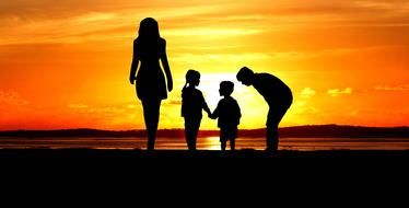 family silhouettes on colorful sunset background