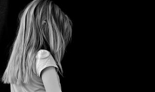 black and white photo of an upset girl