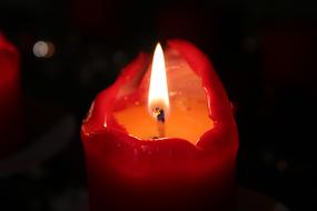 photo of a red burning candle