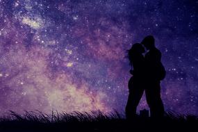 Silhouette of the kissing couple on the magical landscape