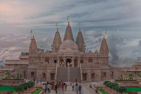 People, near the beautiful temple with the green garden in Pune, India, near the mountains