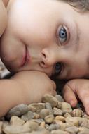 Child with the blue eyes on the stones