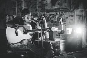 black and white photo of a rock guitarist in a room