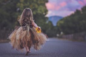 girl in a fluffy dress goes barefoot on the road