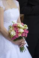 bride with colorful bouquet at ceremony