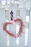 pink wicker heart on the fence