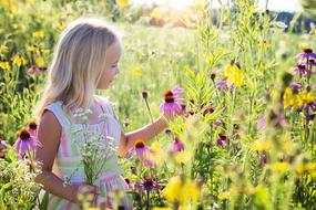 girl in a white dress on a flowering meadow