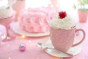 hot chocolate with whipped cream in a pink cup