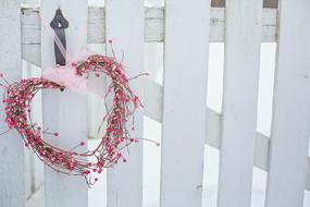 Valentineâs Day Heart with pink ribbon on wooden fence