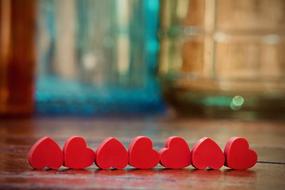 seven small red hearts in row