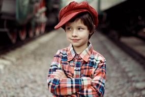 Smiling boy with red cap on blurred background