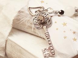 decorative key with chain and pearl