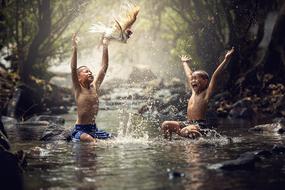 boys are splashing around in Indonesia