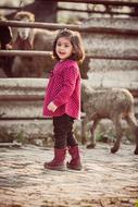 Cute girl with the animals on the farm