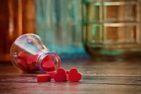 figurines of red hearts in a glass vase