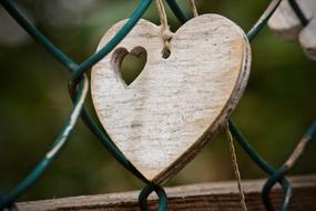 wooden heart on a grate on blurred background