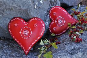 textile red hearts on gray stones