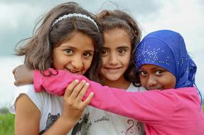 three cute asian child girls together outdoor
