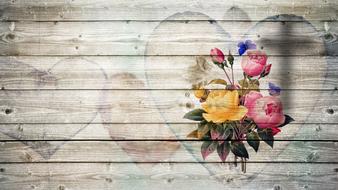 bouquet of flowers in a heart on a wooden background