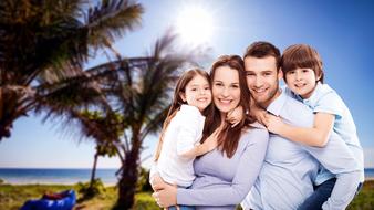 happy young Family with two kids posing at tropical beach background