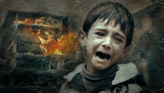 photo of a crying boy on a background of a burning house