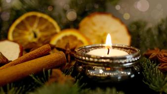 burning candle on the background of Christmas spices